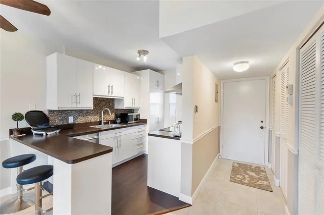 a kitchen with stainless steel appliances a stove a sink a refrigerator and cabinets