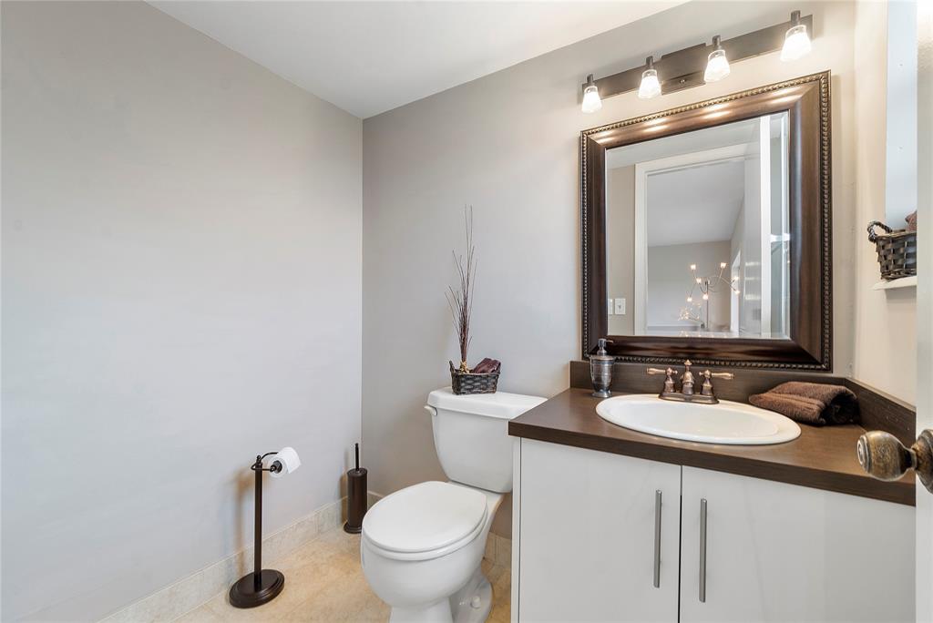 5401 Northwest 2nd Avenue, Unit 322 Boca Raton, FL 33487 - Photo 5 of 7 a bathroom with a toilet a sink and mirror