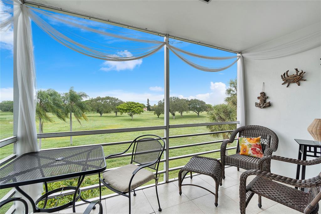 5401 Northwest 2nd Avenue, Unit 322 Boca Raton, FL 33487 - Photo 6 of 7 a view of a chairs and table in patio