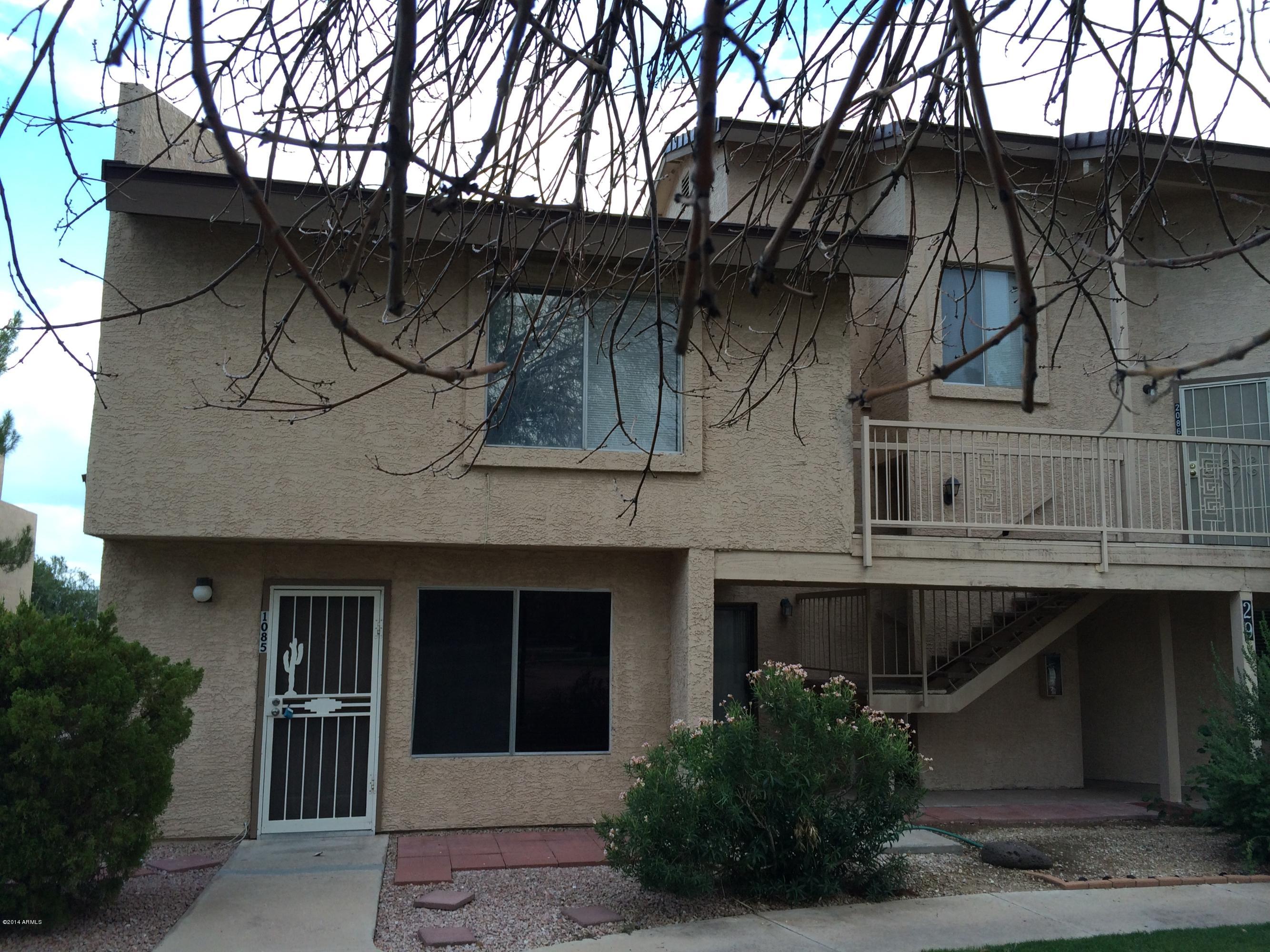 19601 North 7th Street, Unit 1085 Phoenix, AZ 85024 - Photo 1 of 23 a front view of a house with a yard