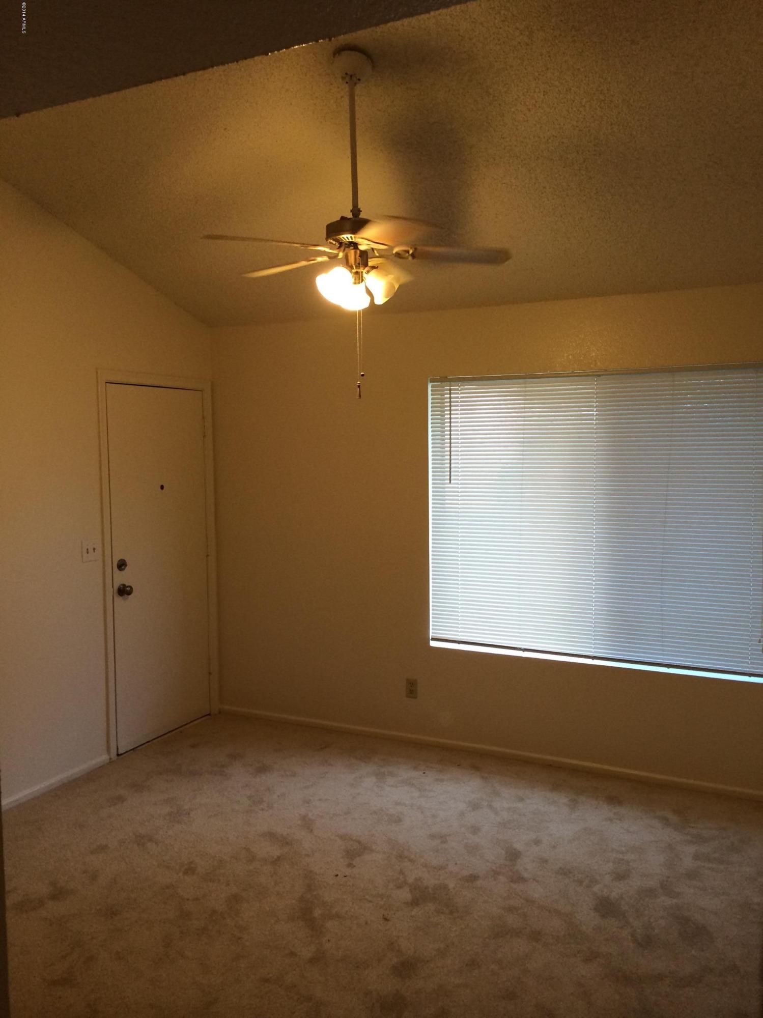 19601 North 7th Street, Unit 1085 Phoenix, AZ 85024 - Photo 12 of 23 a view of a livingroom with a ceiling fan and window