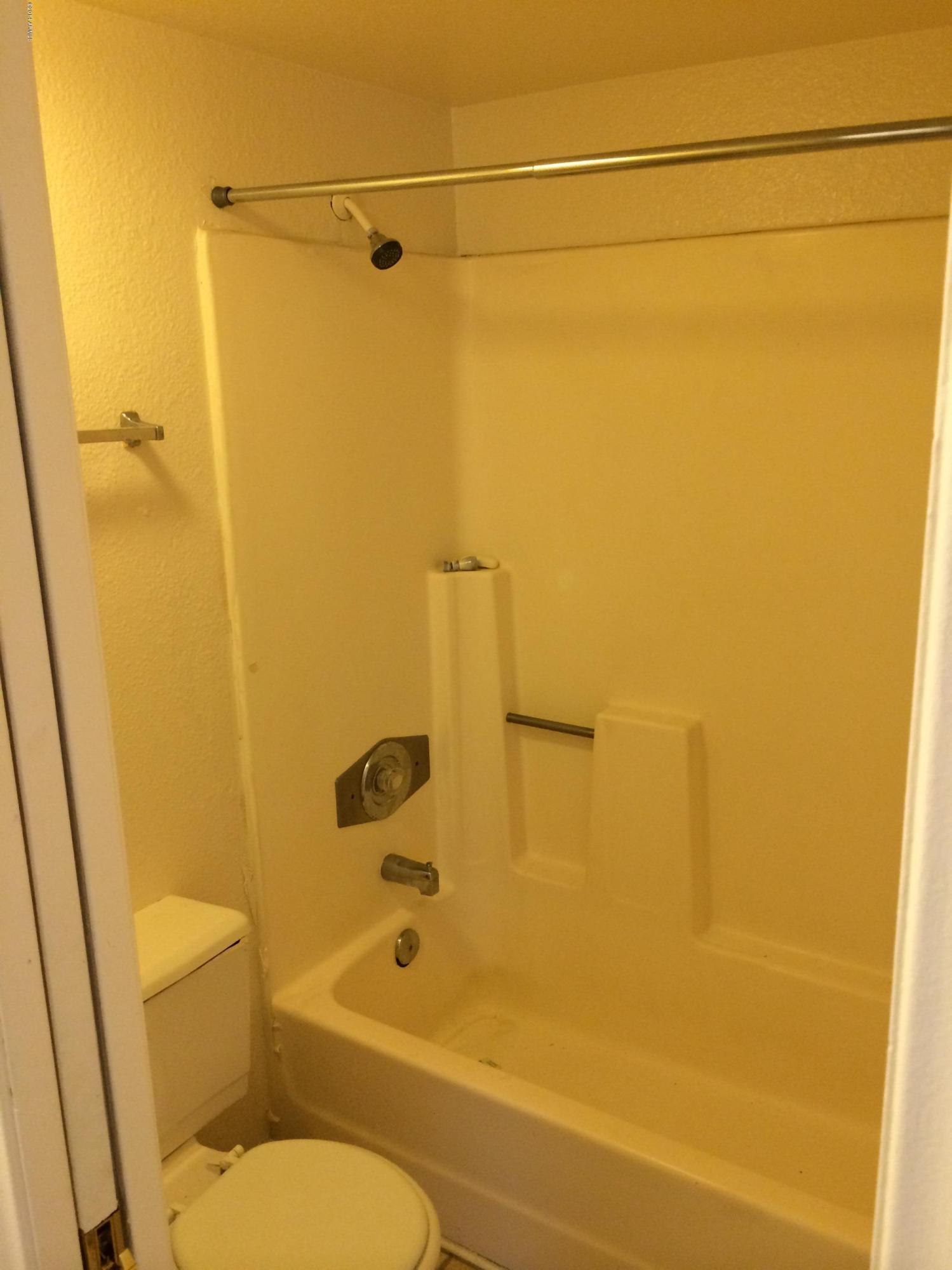 19601 North 7th Street, Unit 1085 Phoenix, AZ 85024 - Photo 13 of 23 a bathroom with a toilet and a shower