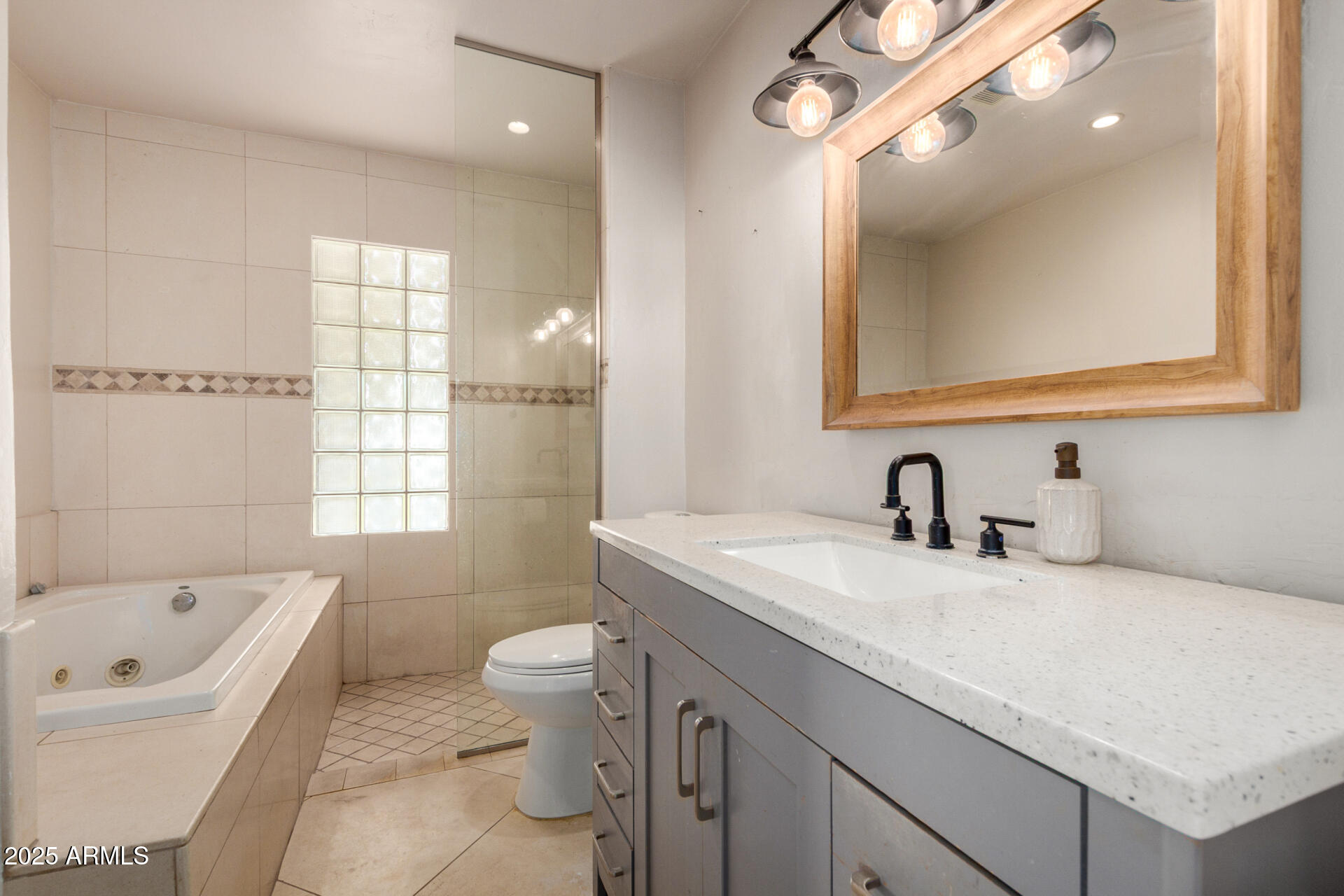 3718 North 36th Street Phoenix, AZ 85018 - Photo 13 of 37 a bathroom with a granite countertop sink a toilet a mirror and bathtub