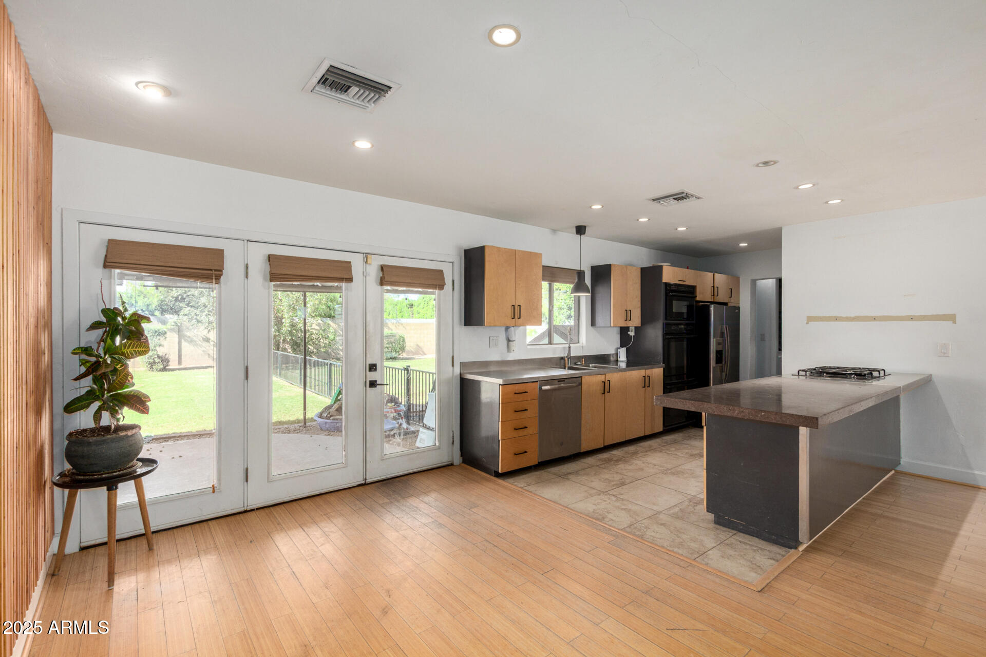 3718 North 36th Street Phoenix, AZ 85018 - Photo 8 of 37 a large kitchen with a lot of counter space and stainless steel appliances