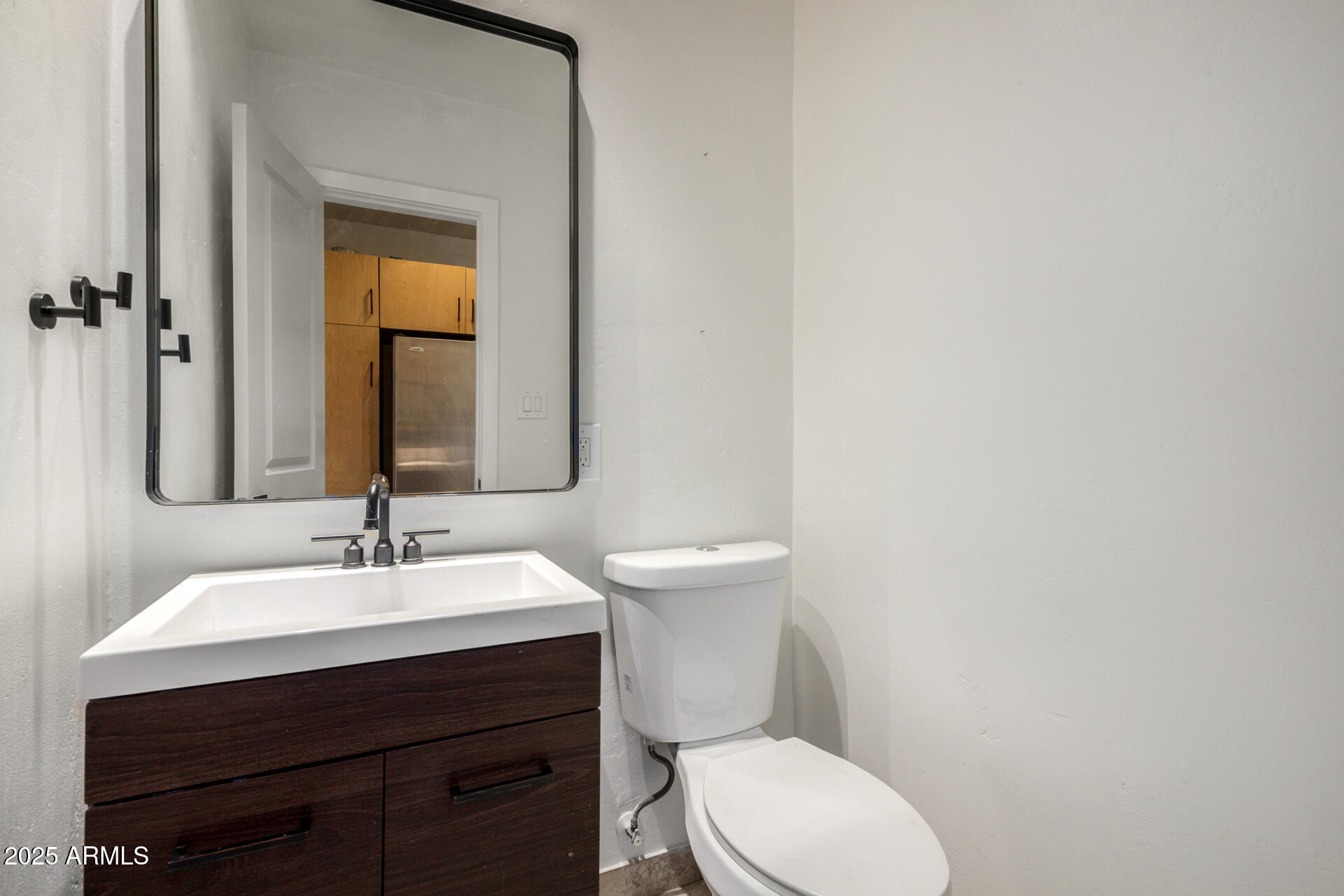 3718 North 36th Street Phoenix, AZ 85018 - Photo 10 of 37 a bathroom with a toilet a sink and mirror