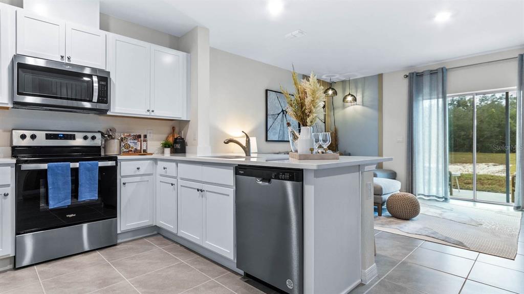 937 Spotted Egret Loop Ruskin, FL 33570 - Photo 9 of 22 a kitchen with a sink and stainless steel appliances