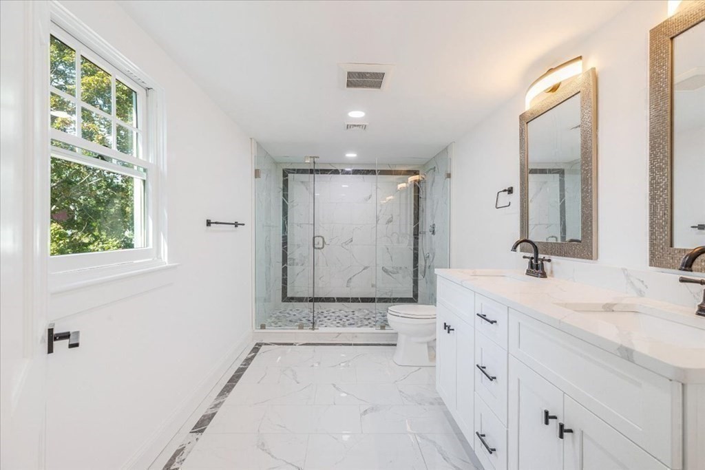964 Main Street Hanover, MA 02339 - Photo 22 of 35 a spacious bathroom with a double vanity sink a mirror and a shower