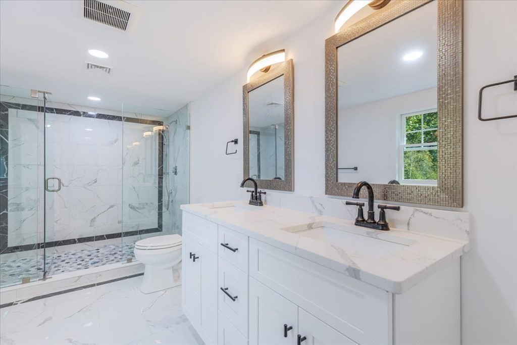 964 Main Street Hanover, MA 02339 - Photo 23 of 35 a bathroom with a double vanity sink mirror double and shower