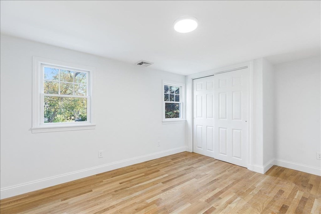 964 Main Street Hanover, MA 02339 - Photo 28 of 35 a view of an empty room with wooden floor and a window