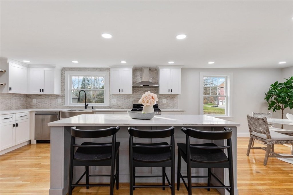 964 Main Street Hanover, MA 02339 - Photo 8 of 35 a kitchen with a table chairs cabinets and wooden floor