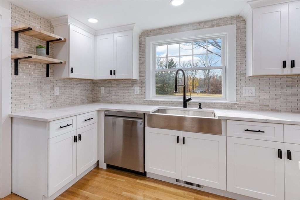 964 Main Street Hanover, MA 02339 - Photo 10 of 35 a kitchen with white cabinets and a window