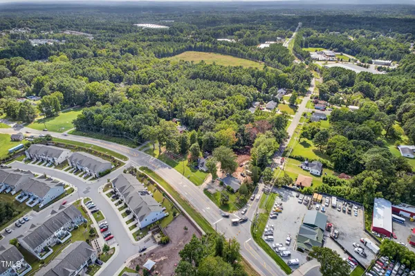 an aerial view of residential houses with outdoor space