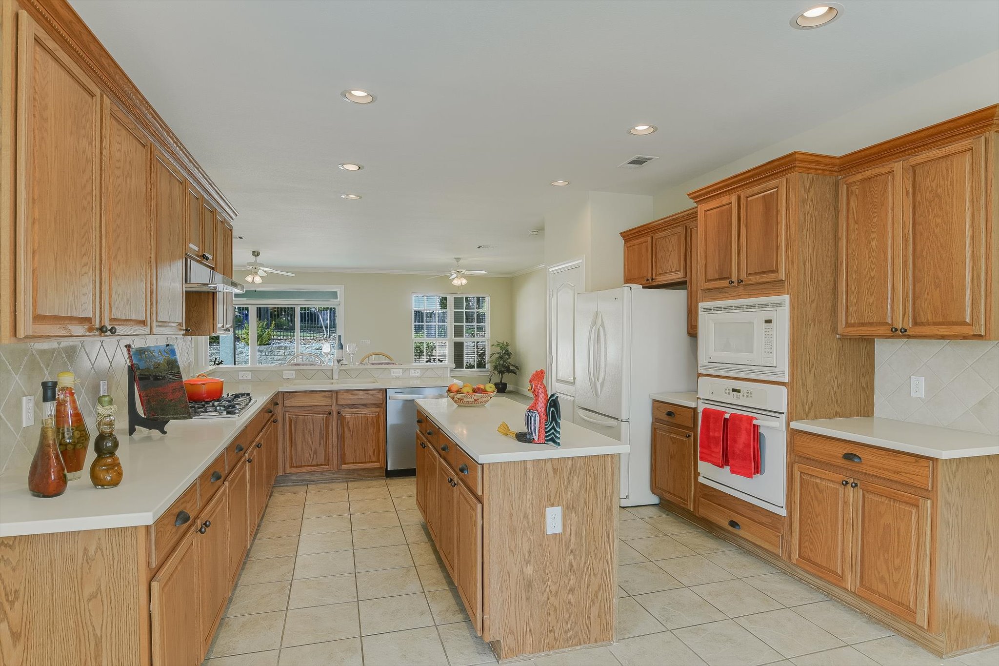 603 Rio Grande Loop Georgetown, TX 78633 - Photo 7 of 27 Kitchen featuring tasteful backsplash, recessed lighting, white appliances, light countertops, and light tile patterned floors