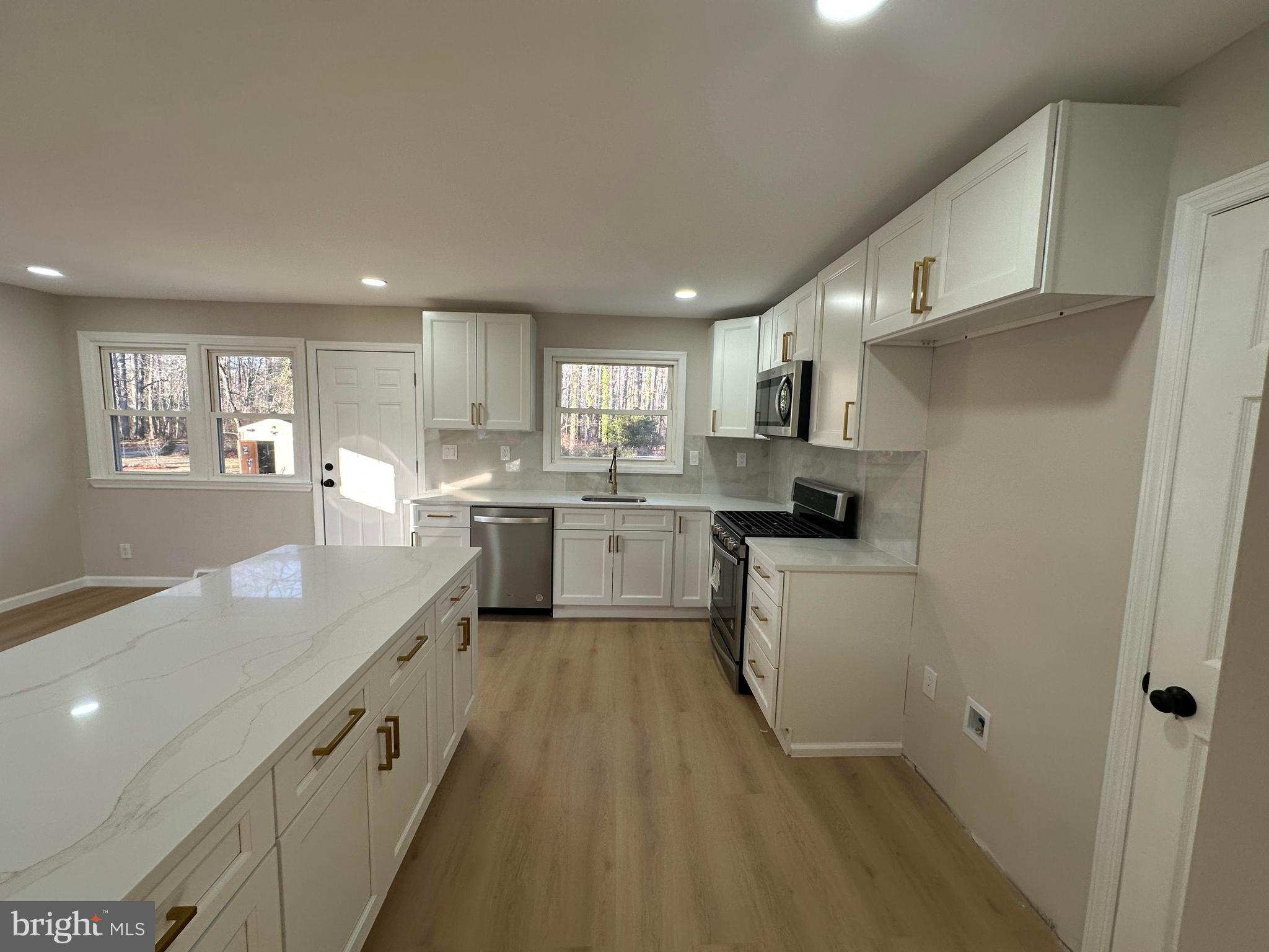 409 Cornwall Road Cherry Hill, NJ 08034 - Photo 5 of 26 a kitchen with stainless steel appliances granite countertop a sink a stove a refrigerator cabinets and a window