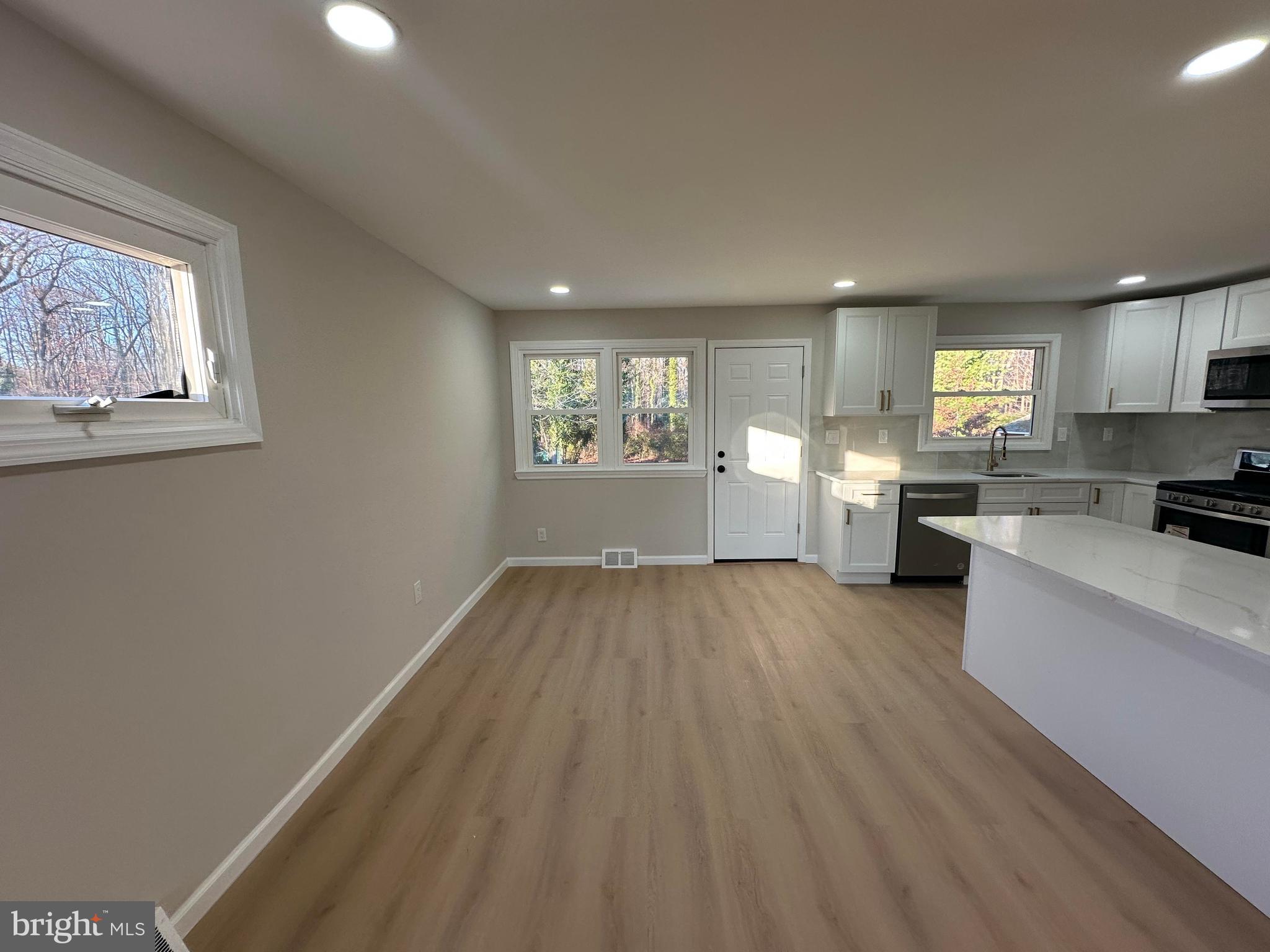 409 Cornwall Road Cherry Hill, NJ 08034 - Photo 9 of 26 a view of empty room with wooden floor and window
