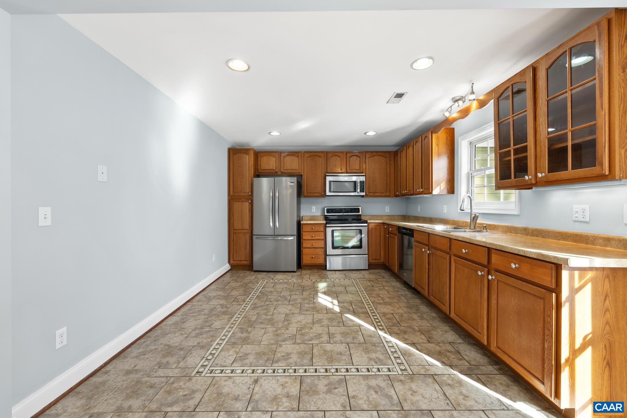 703 Tilman Road Charlottesville, VA 22901 - Photo 12 of 37 a kitchen with stainless steel appliances granite countertop a refrigerator and a sink