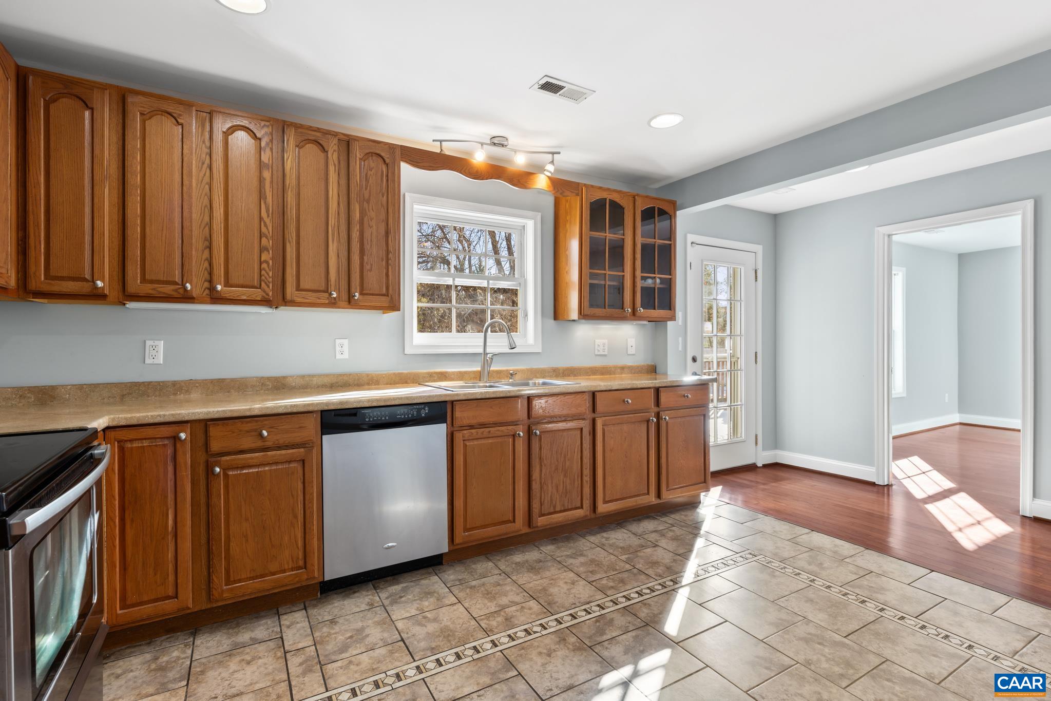 703 Tilman Road Charlottesville, VA 22901 - Photo 13 of 37 a kitchen with stainless steel appliances granite countertop a stove a sink and a microwave