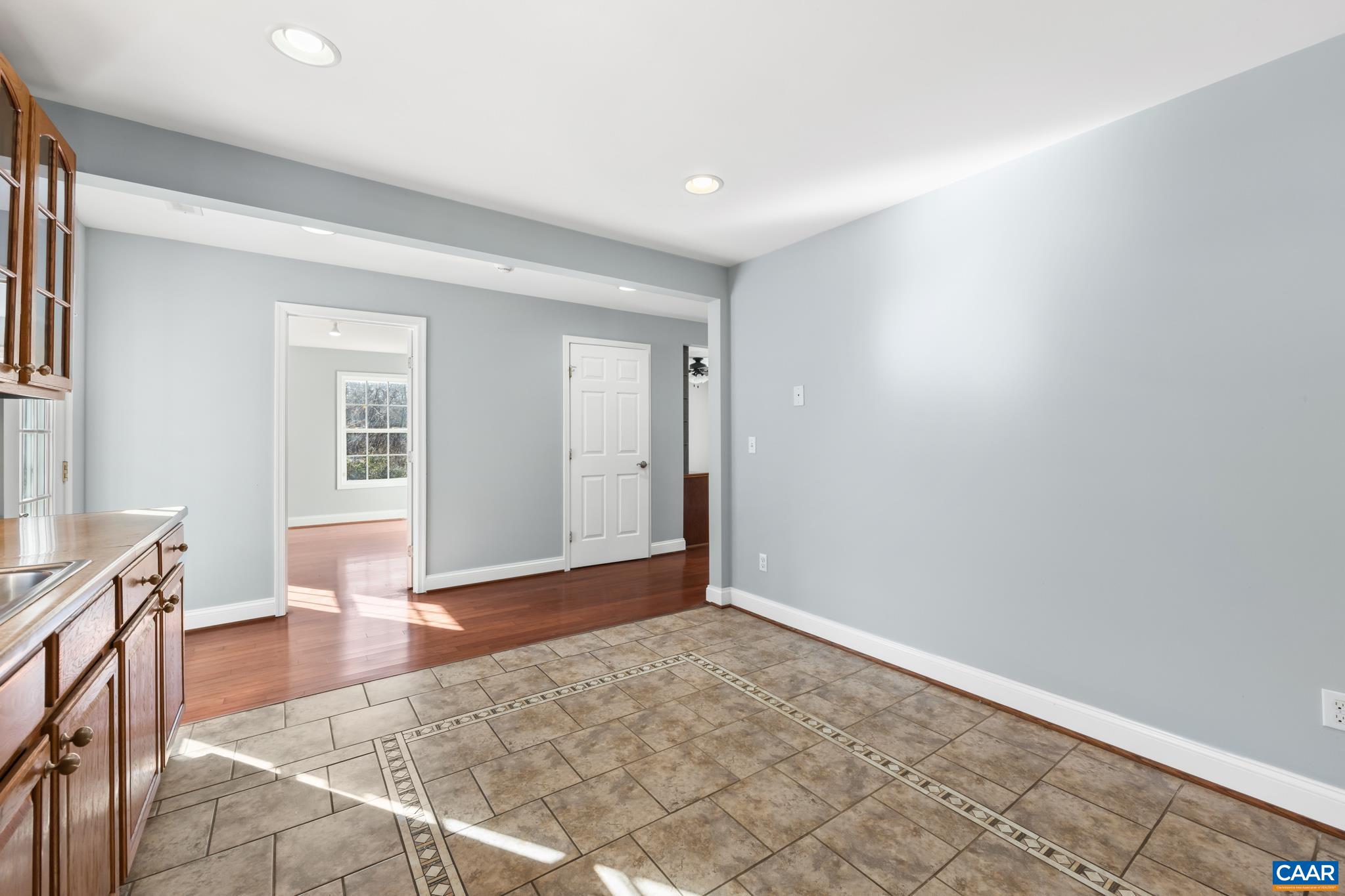 703 Tilman Road Charlottesville, VA 22901 - Photo 14 of 37 an empty room with wooden floor and windows