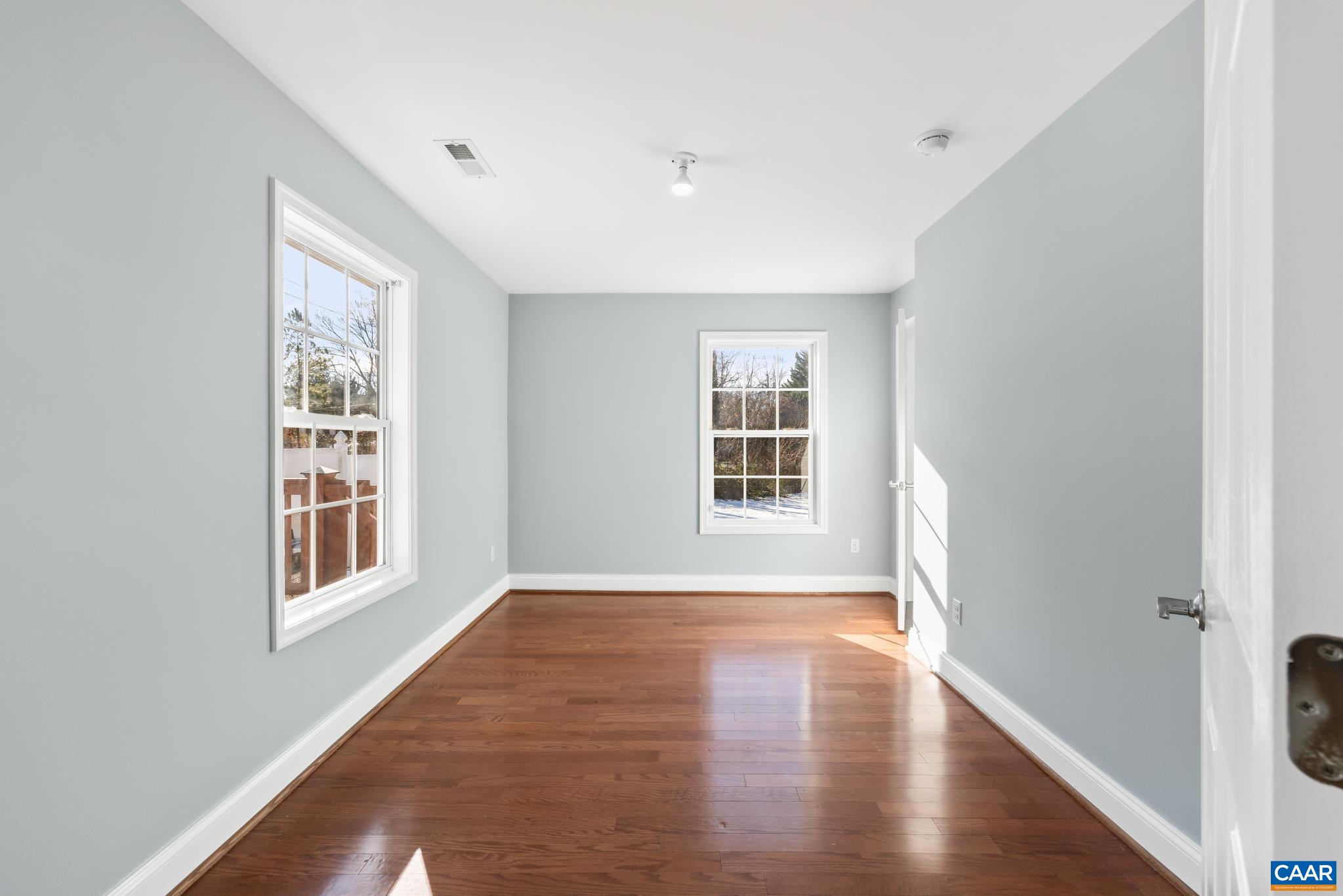 703 Tilman Road Charlottesville, VA 22901 - Photo 15 of 37 a view of an empty room with wooden floor and a window