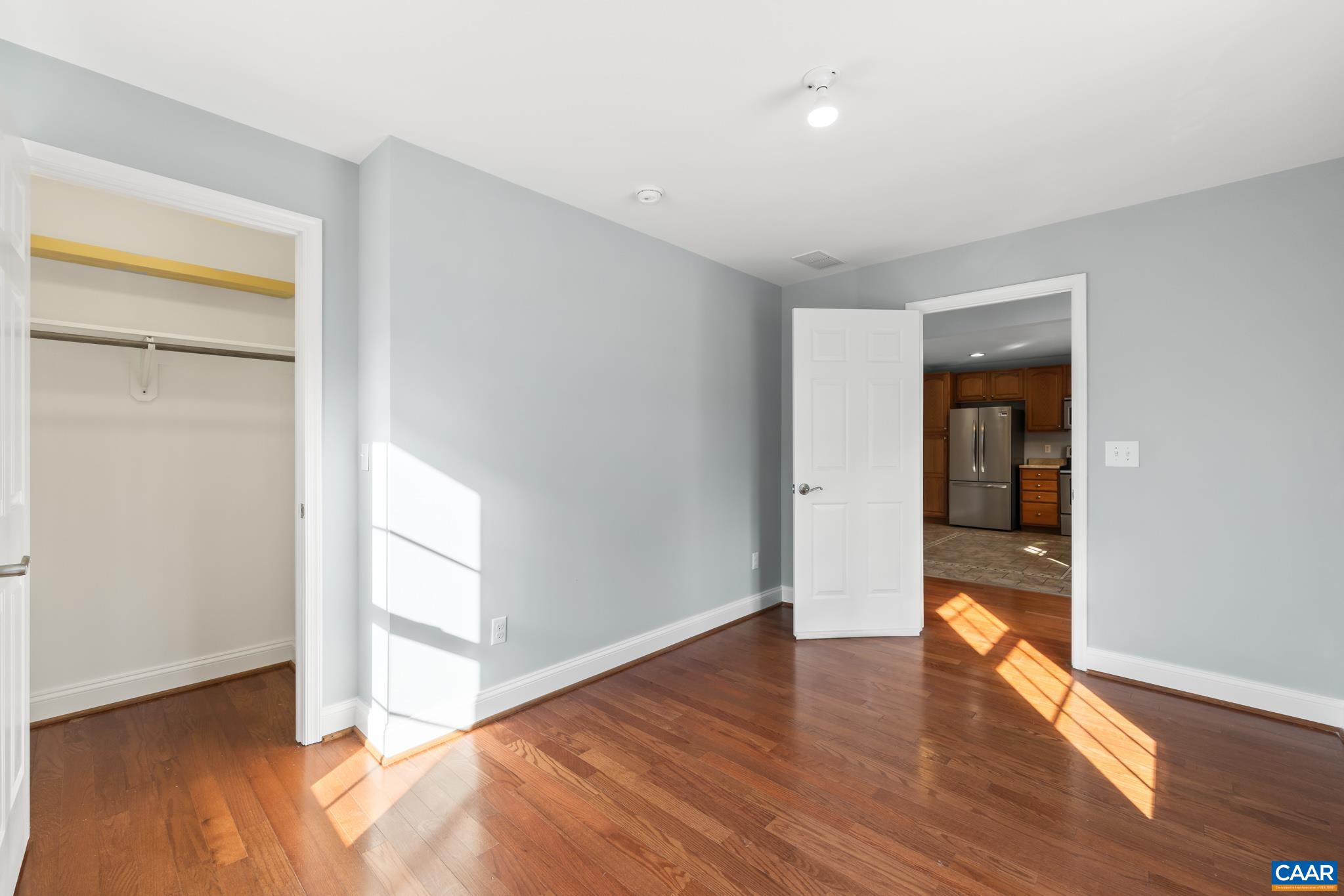 703 Tilman Road Charlottesville, VA 22901 - Photo 16 of 37 an empty room with wooden floor & windows