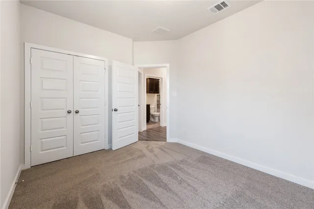 an empty room with closet area