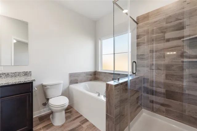 a bathroom with a bathtub and toilet