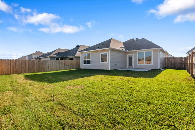 a view of a house with a backyard