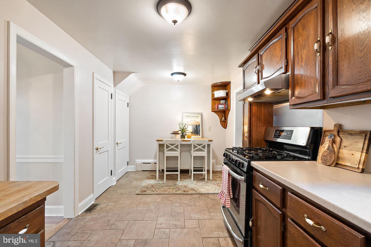 181 East Conestoga Road Wayne, PA 19087 - Photo 12 of 34 a kitchen with a table chairs stove and cabinets