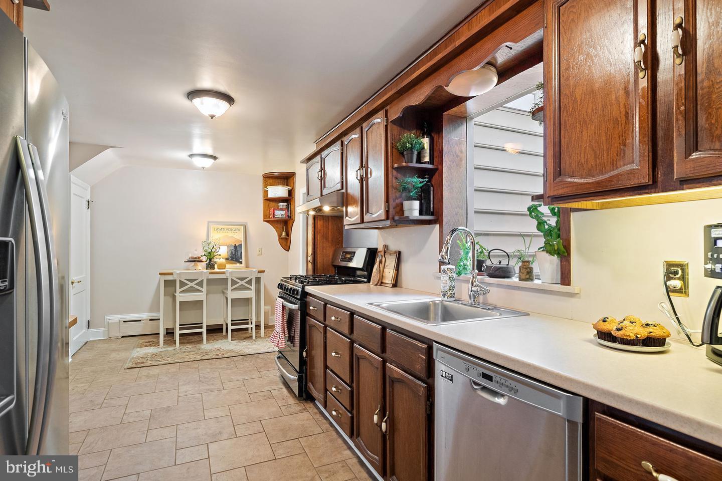 181 East Conestoga Road Wayne, PA 19087 - Photo 13 of 34 a kitchen with stainless steel appliances granite countertop a sink and a refrigerator