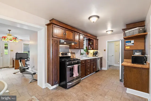a kitchen with stainless steel appliances granite countertop a refrigerator and a stove