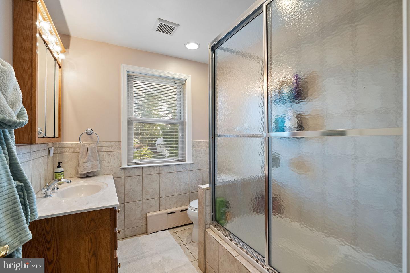 181 East Conestoga Road Wayne, PA 19087 - Photo 27 of 34 a bathroom with a bathtub sink and mirror
