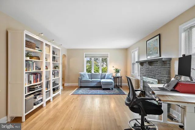 a view of a workspace with furniture and a window