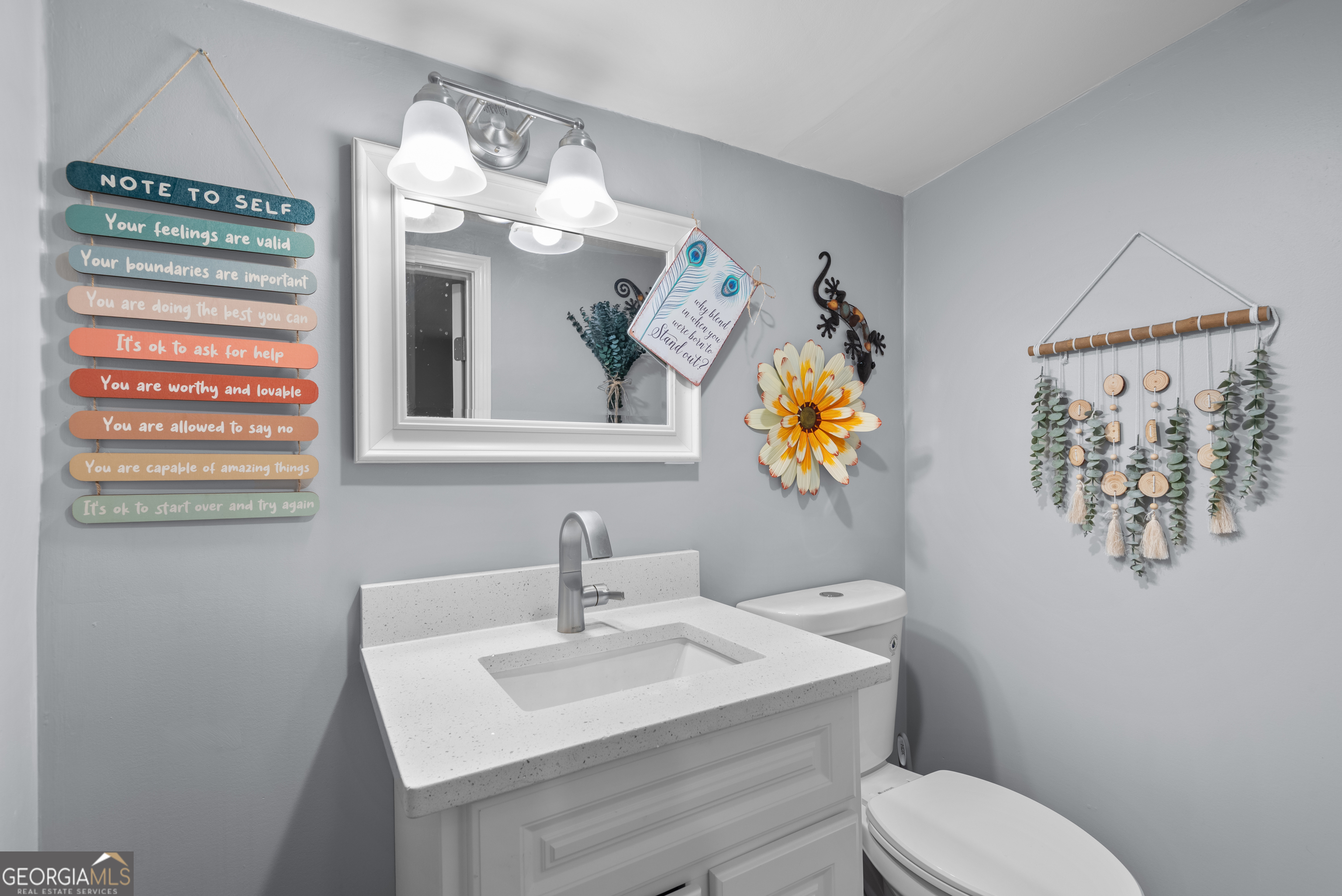 180 Southern Shores Road Jackson, GA 30233 - Photo 23 of 40 a bathroom with a toilet a sink and mirror