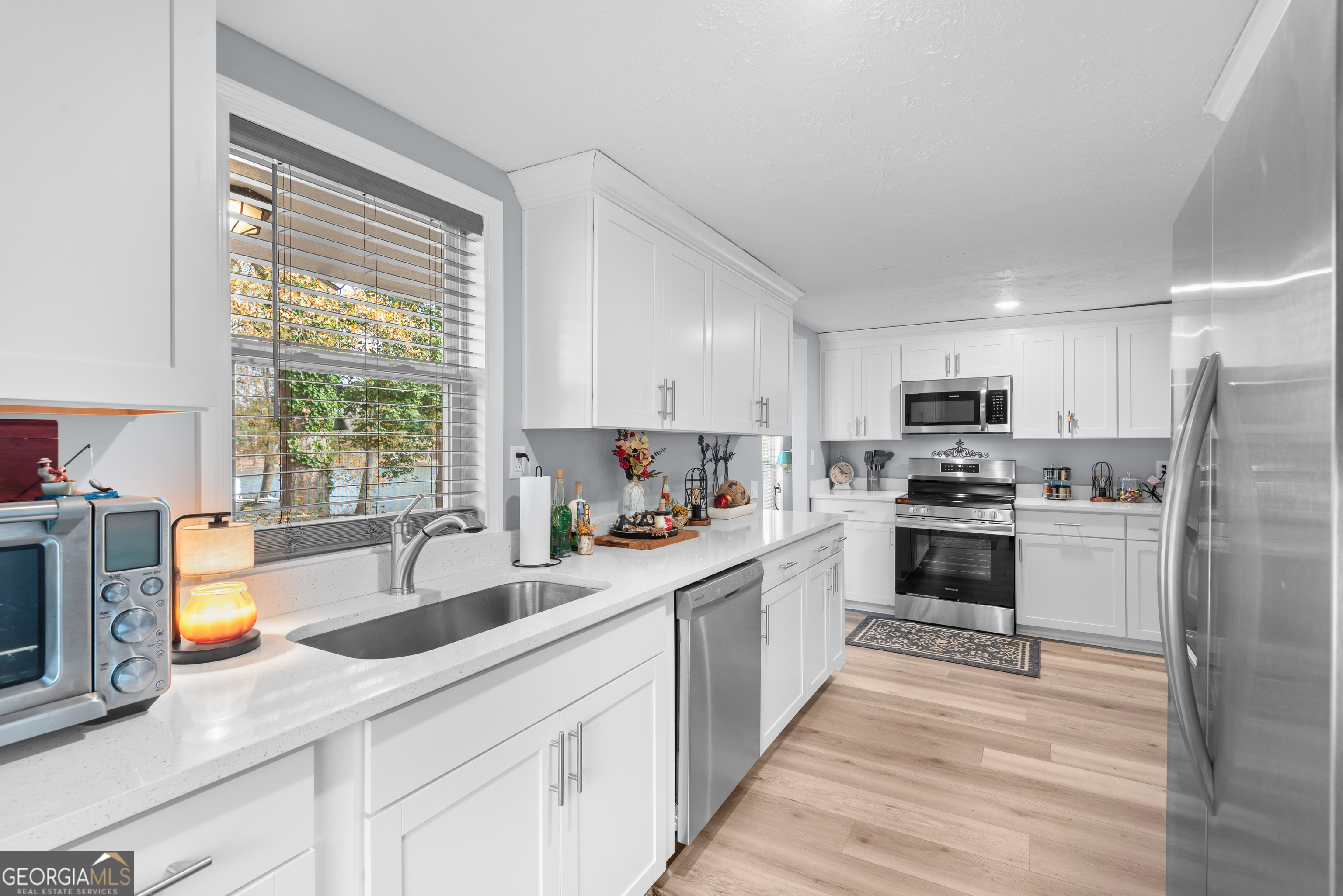 180 Southern Shores Road Jackson, GA 30233 - Photo 10 of 40 a kitchen with white cabinets and white appliances