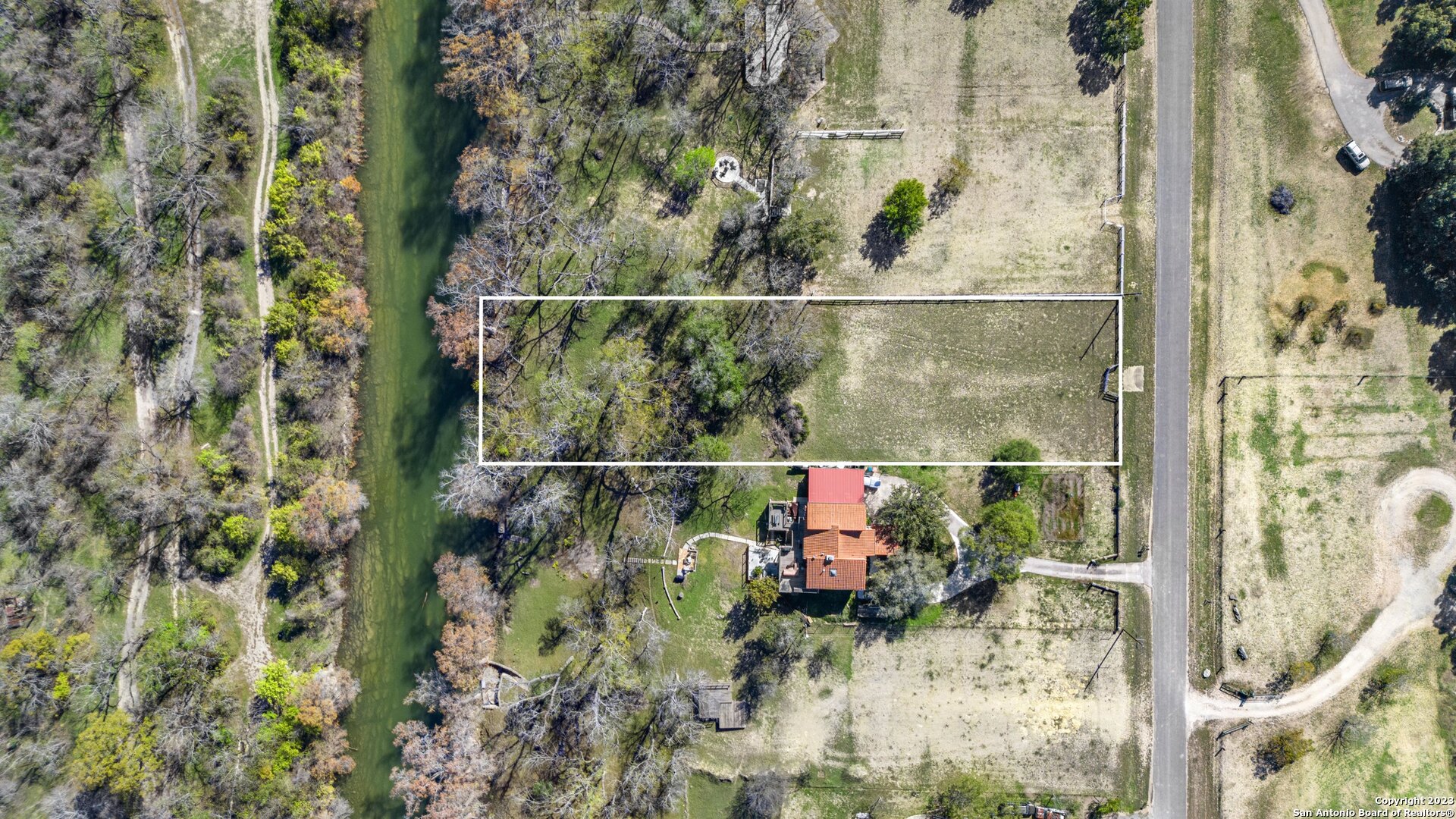 1236 Whispering Water Spring Branch, TX 78070 - Photo 21 of 22 a backyard of a house with lots of green space and glass windows
