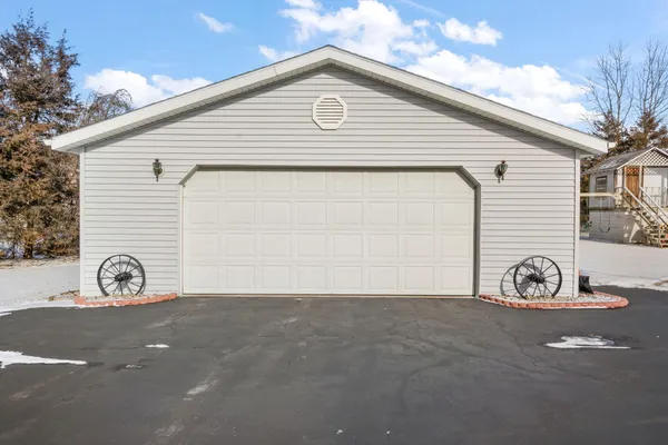 a view of a house with a yard and parking space