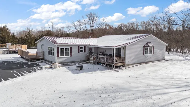 a view of a house with a snow in the yard