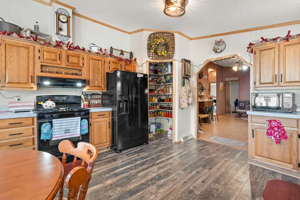 a kitchen with stainless steel appliances granite countertop a refrigerator and a stove top oven