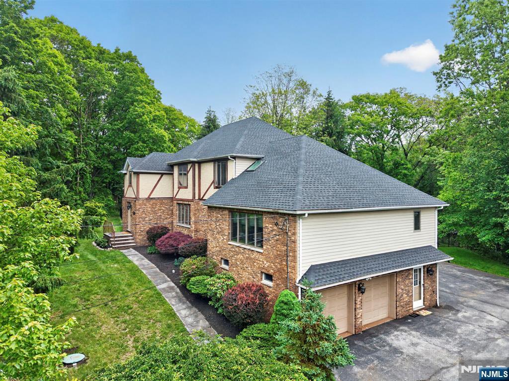 5110 Berkshire Valley Road Oak Ridge, NJ 07438 - Photo 1 of 49 a aerial view of a house with a yard plants and large tree