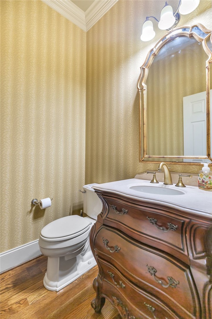 114 Willowbend Drive Anderson, SC 29621 - Photo 27 of 50 This bathroom showcases a vanity with an ornate mirror, hardwood flooring, and crown molding.
