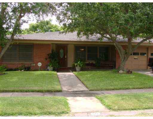 a front view of a house with a garden and yard