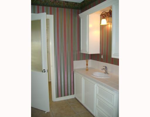 609 Peerman Place Corpus Christi, TX 78411 - Photo 6 of 10 a bathroom with a sink and a mirror