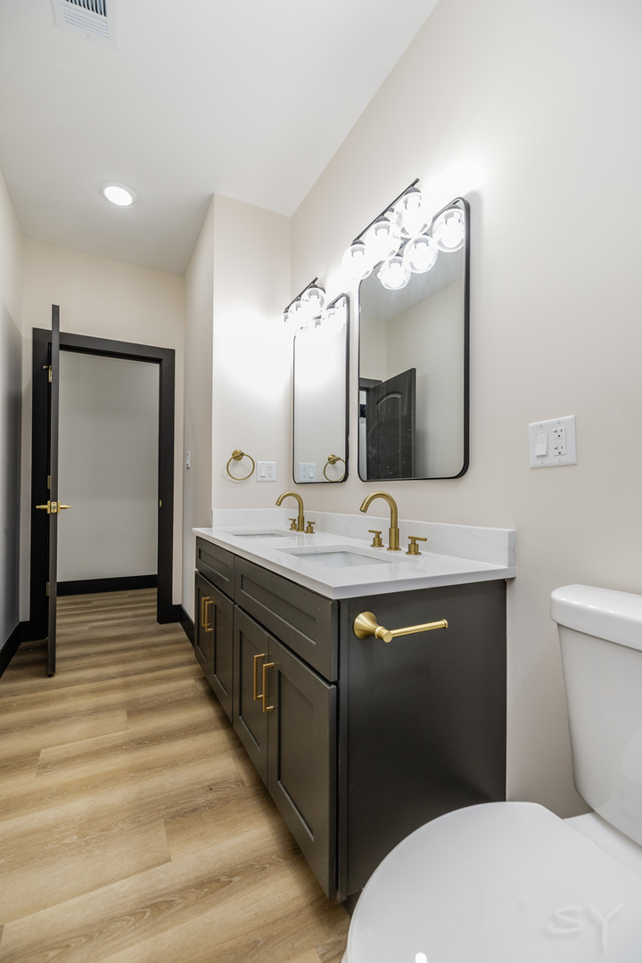 5637 South Prairie Avenue Chicago, IL 60637 - Photo 12 of 17 a bathroom with a double vanity sink mirror and toilet