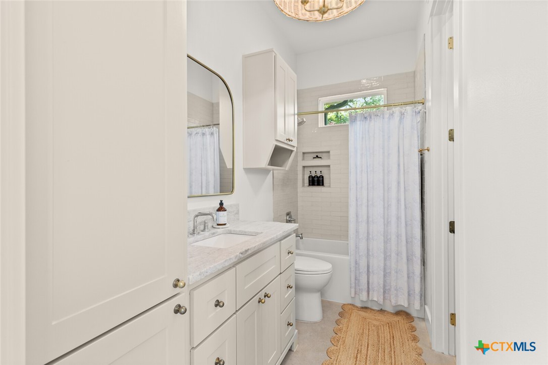 1007 Rivers Edge Drive Belton, TX 76513 - Photo 27 of 48 a bathroom with a double vanity sink toilet and shower