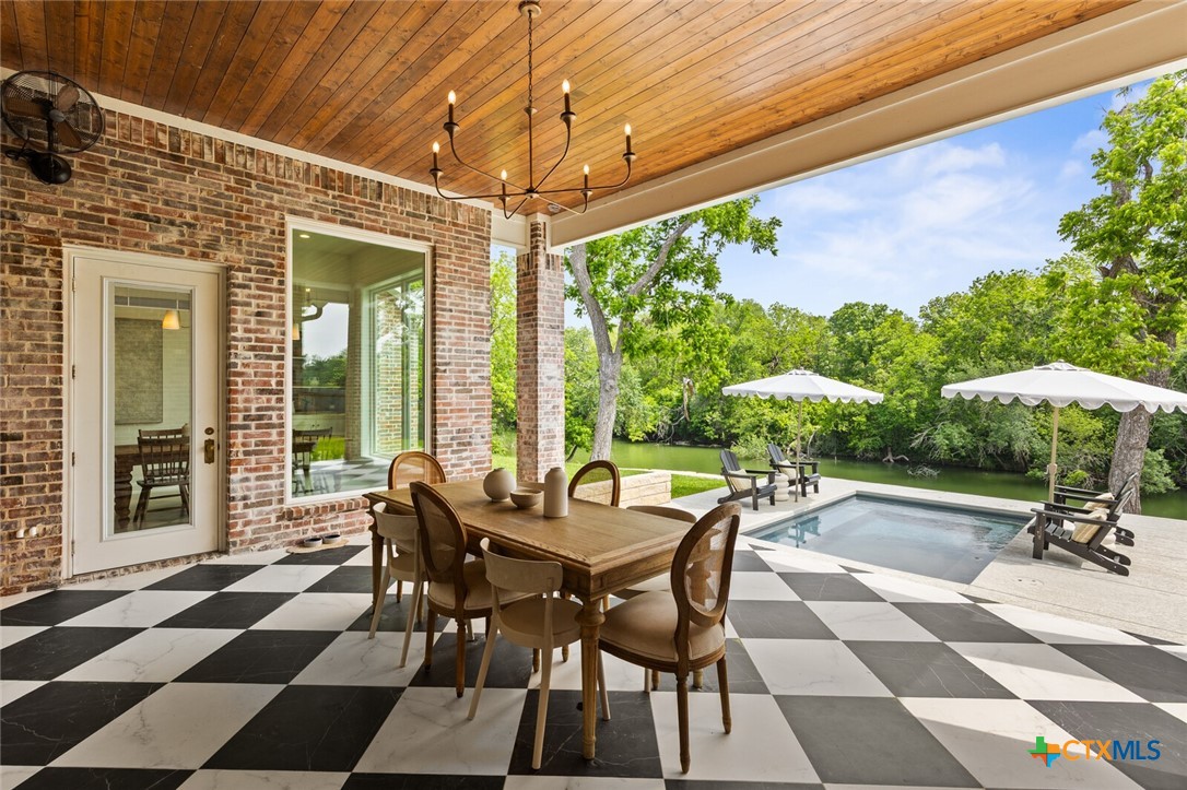 1007 Rivers Edge Drive Belton, TX 76513 - Photo 42 of 48 a view of a patio with a table and chairs under an umbrella