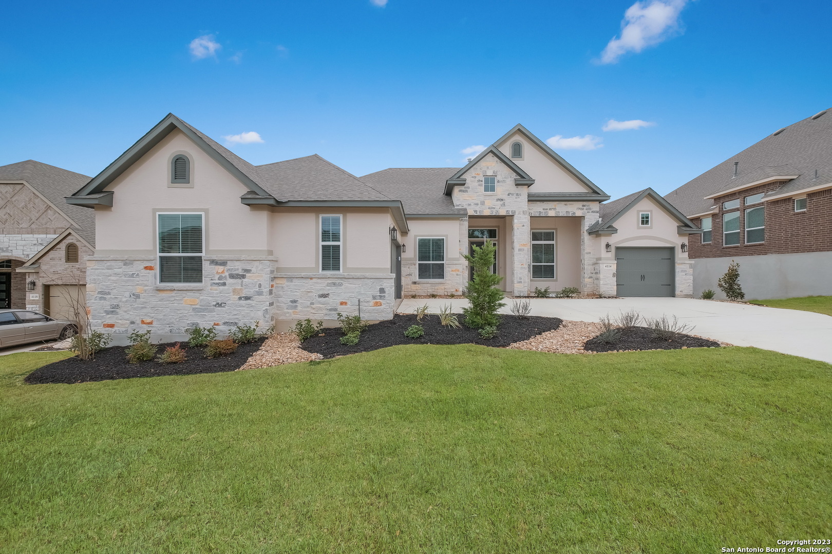 a front view of a house with a yard and garage