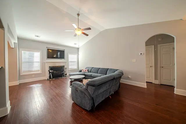a living room with furniture and a fireplace