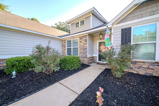 a front view of a house with garden