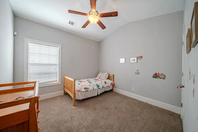 a bedroom with bed and window