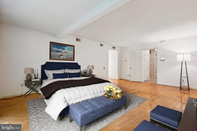 a bedroom with a bed and a couch